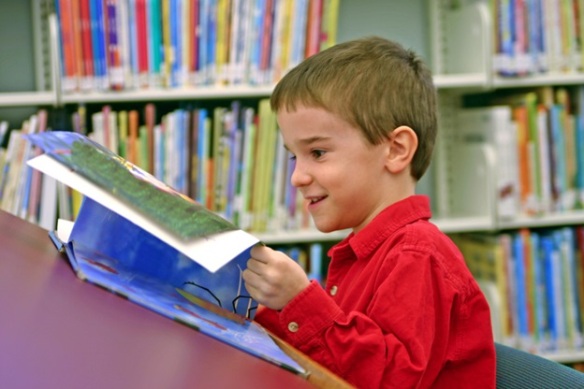 boy reading library